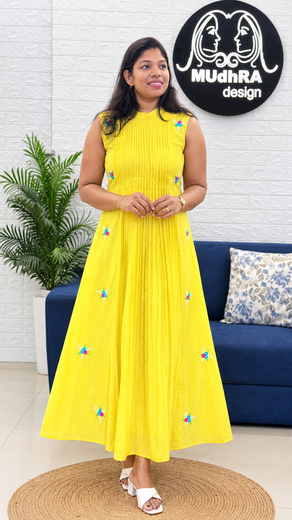 Front view of the butter yellow Chanderi frock with a band collar and ankle-length flare, at the Mudhra Design boutique